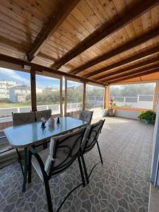 a patio with a table and chairs on a balcony at Family Getaway Close the Sea in Ayía Marína