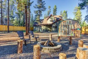 a backyard with a bird cage and a fire pit at Spacious Three Rivers Lodge✦Fenced .5 Acre✦Hot Tub in Bend