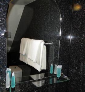 a bathroom with a mirror and a toilet and towels at The Old Black Horse Inn in Oxford