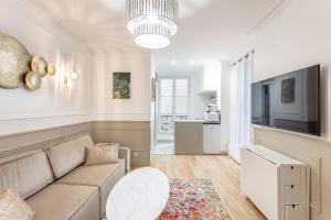 a living room with a couch and a table at SUITE RAPHAEL Tour Eiffel in Paris