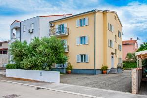 an apartment building in a parking lot at Apartments Bella B in Rovinj