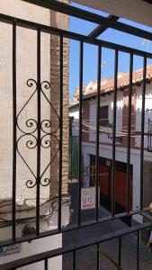 uma vista para um edifício através de uma cerca de metal em Casa Carmen em Granada