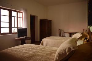 a hotel room with two beds and a window at Casa San Martin Suites in Cochabamba