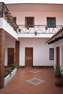 a courtyard of a house with a wooden door at Casa San Martin Suites in Cochabamba