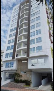 a large white apartment building with at Jade Aparts Salinas in Salinas