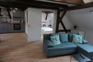 a living room with a couch and a bedroom at Wohlfühl-Oase in der Altstadt in Delitzsch