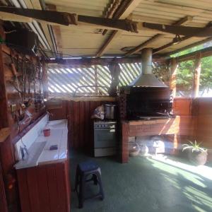 a kitchen with a stove and a stove top oven at Cabaña con estacionamiento in Panguipulli