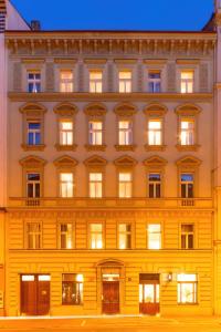 a large yellow building with many windows at S42 Hotel Prague in Prague
