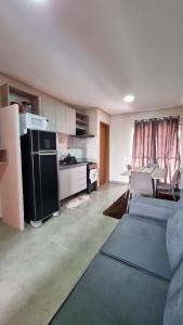 um quarto com uma cozinha e uma sala de estar com um sofá em Apartamento Sossego em Luís Correia