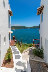 a view of the water from between two buildings at Villa Orion in Arraial do Cabo
