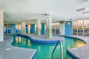a large swimming pool in a large building at Ocean Blue Condos by Coastline Resorts in Myrtle Beach