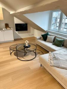 uma sala de estar com um sofá e uma mesa em Duplex hyper centre em Liège