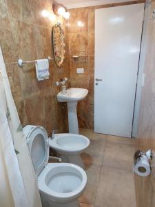 a bathroom with a toilet and a sink at La Soñada II in Alta Gracia +9 photos