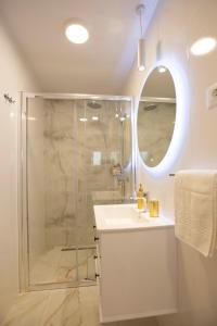 a bathroom with a shower and a sink and a mirror at Guest House Paradise in Split