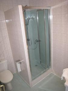 a shower with a glass door in a bathroom at La Renaissance in Arlanc +32 photos