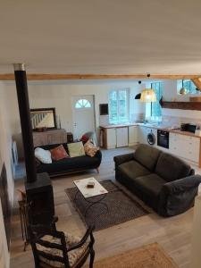 a living room with a couch and a stove at Baia, Une charmante maison avec jardin in Flagy