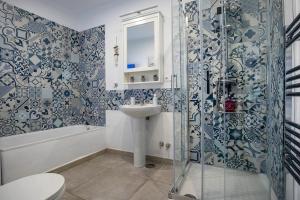 a bathroom with a toilet and a sink and a shower at Casa Corbeto 43 in Cómpeta