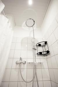 a shower in a white tiled bathroom at SH Team Lodges 4 Apartments für max 19 Personen l Monteure l Messe l Business in Duisburg
