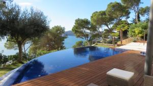 a swimming pool on a roof with a view of the water at Blueview Villa in Llafranc