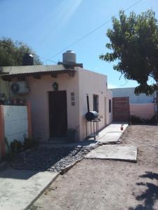 una pequeña casa blanca con entrada en Aldos en San Antonio Oeste