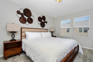 a bedroom with a white bed and a window at Stunning 4 Bd w/ GameRoom Close to Disney 5110K in Kissimmee