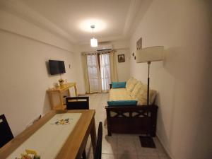 a living room with a couch and a table at LA SAN JUAN en Zona Norte in San Miguel de Tucumán