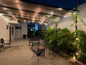 un patio con luci, sedie e piante di Aldeazul by Andiani Travel a Cancún