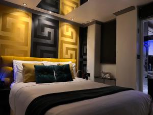 a bedroom with a large bed with a yellow headboard at Exclusive Apartments South Kensington in London