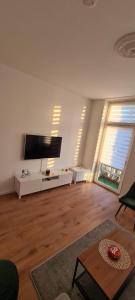 a large living room with a large flat screen tv at 2Zimmer Apartment mit Stellplatz in Krefeld