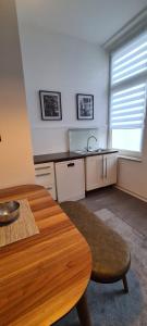 a kitchen with a wooden table and a sink at 2Zimmer Apartment mit Stellplatz in Krefeld