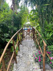 a wooden bridge in a garden with flowers at El Time in Tijarafe