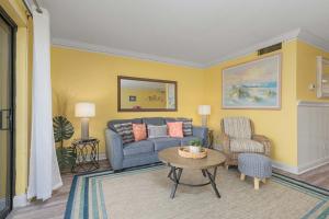 a living room with a couch and a table at Bent Palm 218 in Ormond Beach