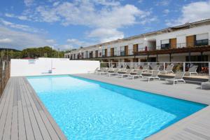 una gran piscina con sillas y un edificio en Studio Nuitée en Provence 2 en Aix-en-Provence