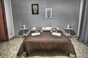 a bedroom with a large bed with two tables at La Casa del Moro - Al Politeama in Palermo