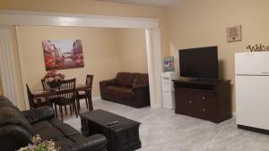 a living room with a couch and a television at Vacation Lake View House kelowna BNB in Kelowna