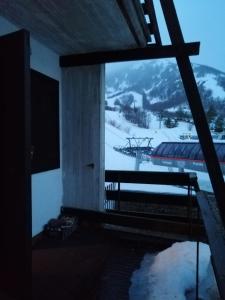 a room with a view of a snow covered mountain at Residence il Cristallo - Appartamento in Ovindoli