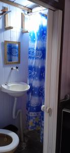 a bathroom with a sink and a shower curtain at Pousadinha da Liza in Mangaratiba