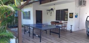 a ping pong table in the middle of a patio at Aconchego em Floripa in Florianópolis