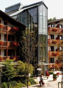 a glass building with a person sitting in front of it at Kurhotel Bad Zell in Bad Zell