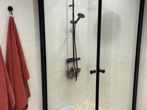 a shower stall with a glass door and a shower at Holiday home PRÄSSEBO II in Eckerud