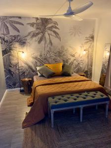 a bedroom with a bed with a mural of palm trees at Colors by MG2 in Saint Martin
