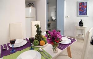 a dining room table with a pineapple and fruit on it at Stunning Home In Frigiliana With 2 Bedrooms And Wifi in Frigiliana