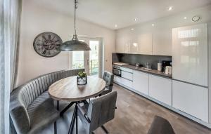 a kitchen and dining room with a table and chairs at Rottummeroog in Den Oever