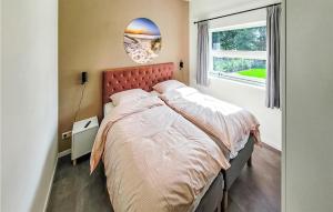 a bedroom with a large bed and a window at Rottummeroog in Den Oever +6 photos