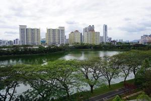 a river in front of a city with tall buildings at Romance in de house 3-5pax Two Parking Free, There is a shopping mall downstairs in Kuala Lumpur