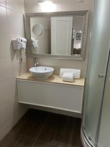 a bathroom with a sink and a mirror at Hotel Alvear in Montevideo
