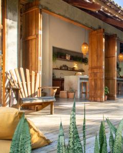 a patio with a chair and a table at Casa Canoa - Praia de Algodões in Marau