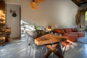 a living room with a wooden table and a couch at Casa Canoa - Praia de Algodões in Marau