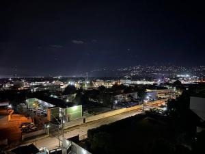 a view of a city at night with lights at Harloes Luxury Suite - Kingston Jamaica in Kingston