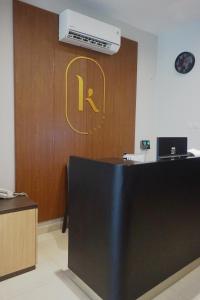 an office with a wooden door with a letter r on it at Kanna Stay in Semolowaru